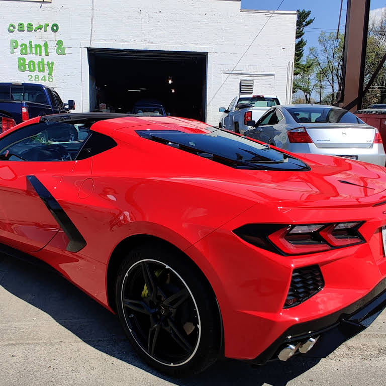 Red Corvette outside the shop at 2846 West Broad Street, with the original Castro Paint and Body sign
